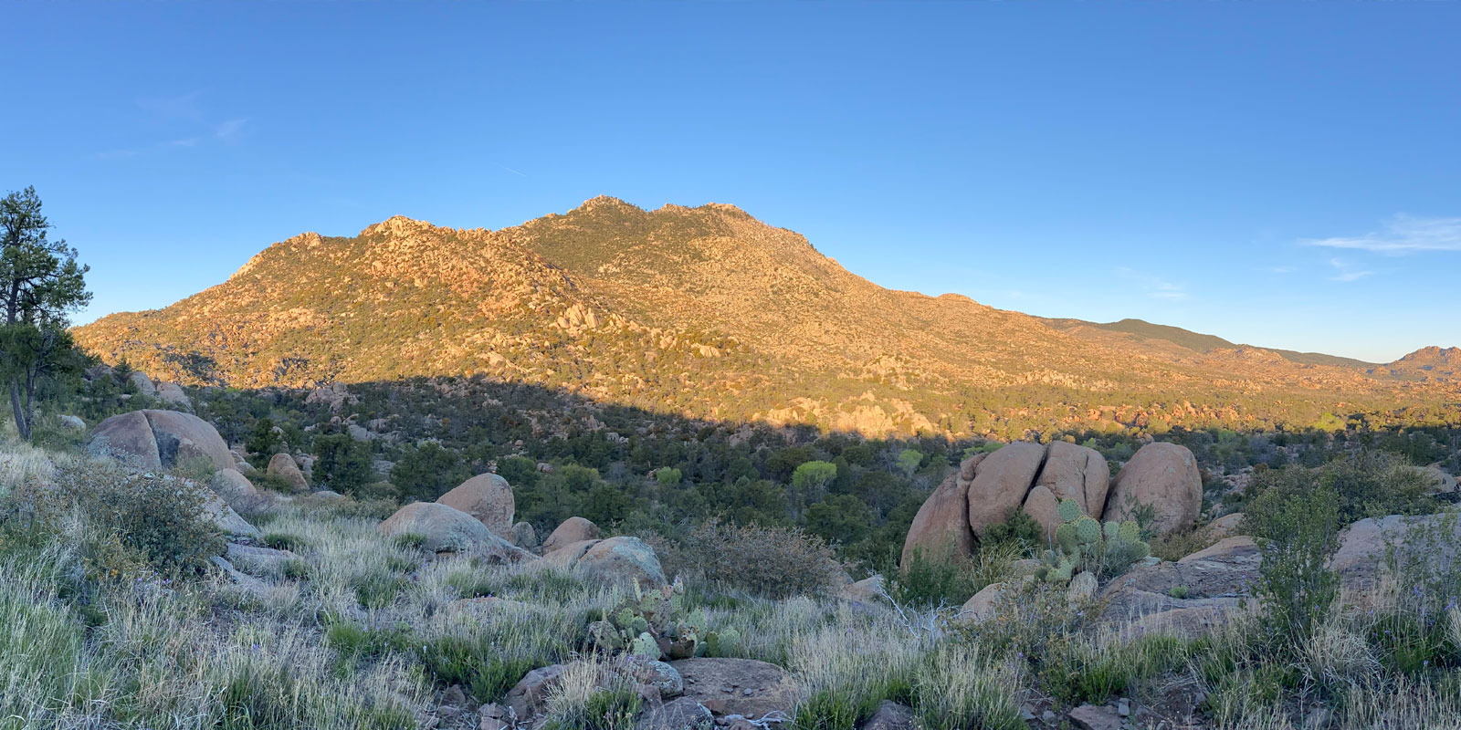 A hill in Prescott, AZ surrounded by solid rocks.